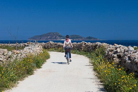 Cyclists exploring the coastal roads of Favignana