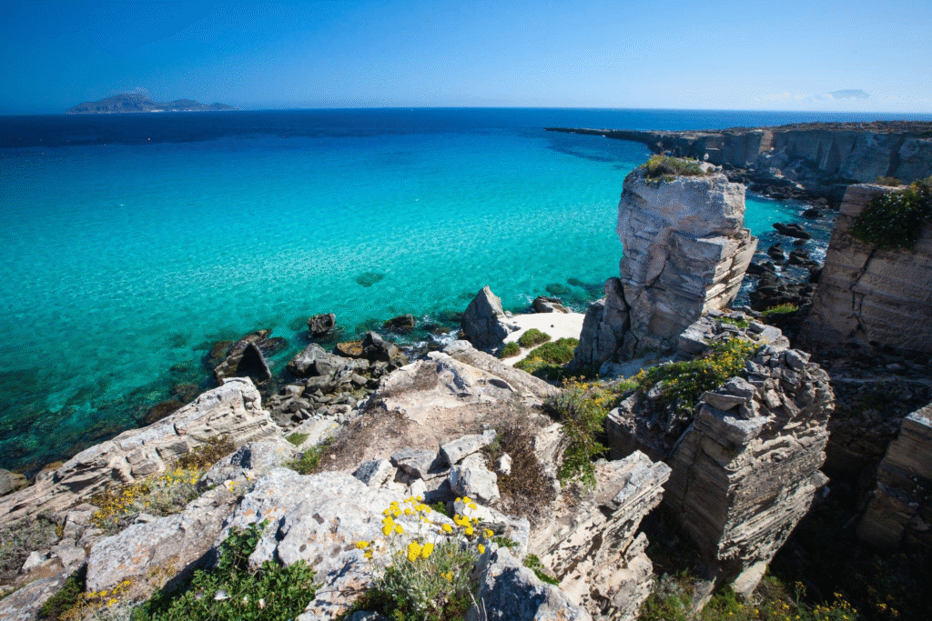 Cala Azzurra beach and clear Mediterranean water in Favignana