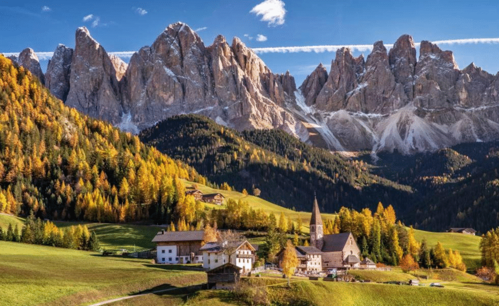 Golden larch forests beneath the Dolomite mountains in autumn