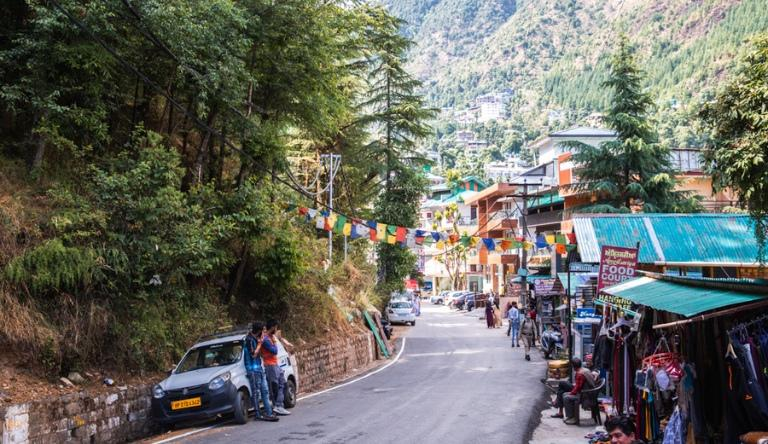 Narrow lane in McLeod Ganj lined with Tibetan prayer flags